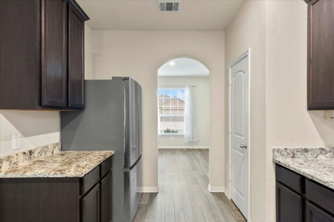 Kitchen featuring dark wood finish cabinetry, fre