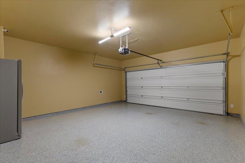 Garage featuring freestanding refrigerator and a 
