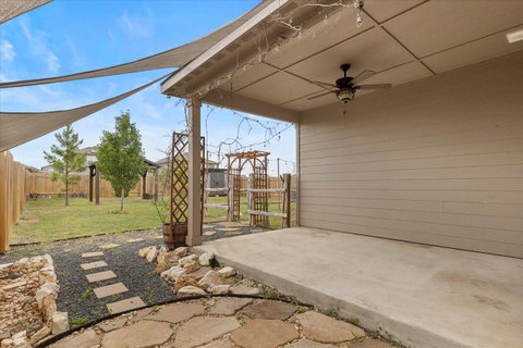 Fenced backyard featuring a patio and a ceiling f