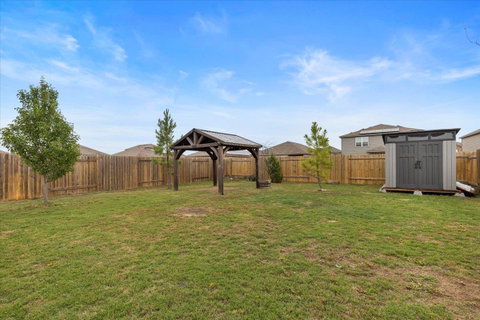 Fenced backyard with a shed