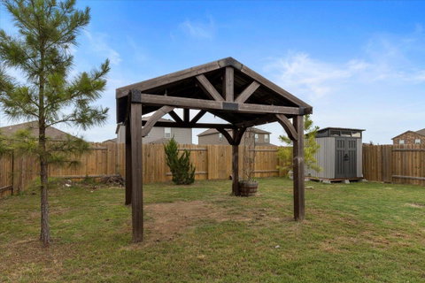 Fenced backyard with a storage shed
