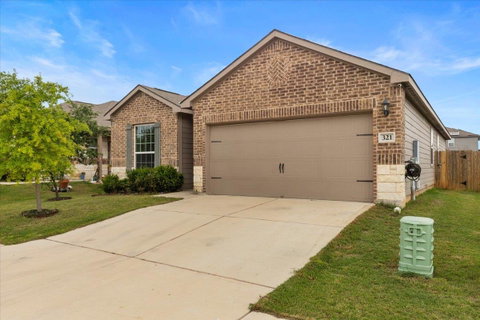 Single story home with an attached garage, brick 