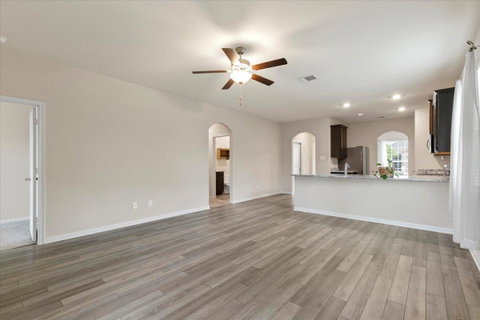 Unfurnished living room with ceiling fan, light w