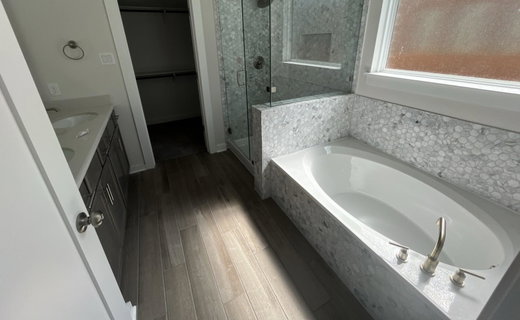 Bathroom featuring double vanity, a spacious clos