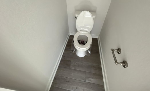 Bathroom with baseboards and wood finished floors