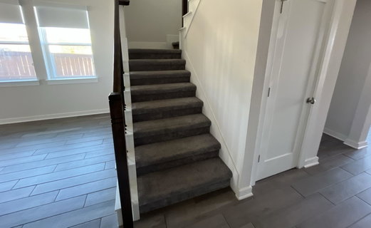 Stairway featuring wood finished floors and baseb