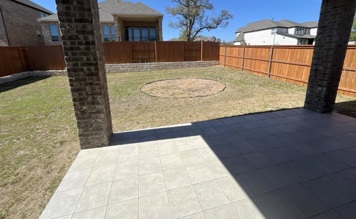 Fenced backyard with a patio area