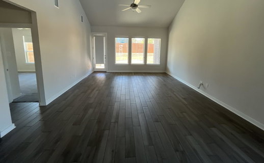 Unfurnished room with a ceiling fan, lofted ceili