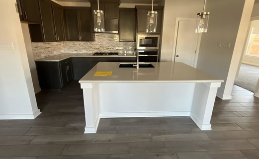 Kitchen featuring hanging light fixtures, wood ti